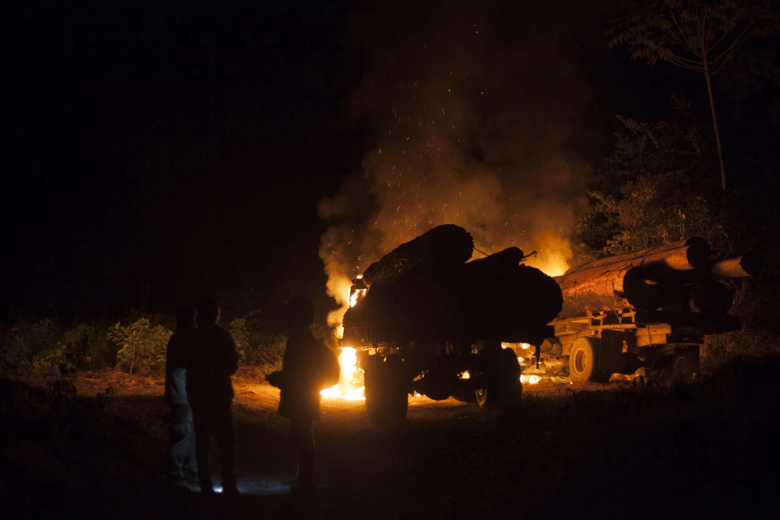 *Image of trees that had been illegally logged in indigenous territory being burned along with trucks to ensure the destruction of illegal logging equipment.