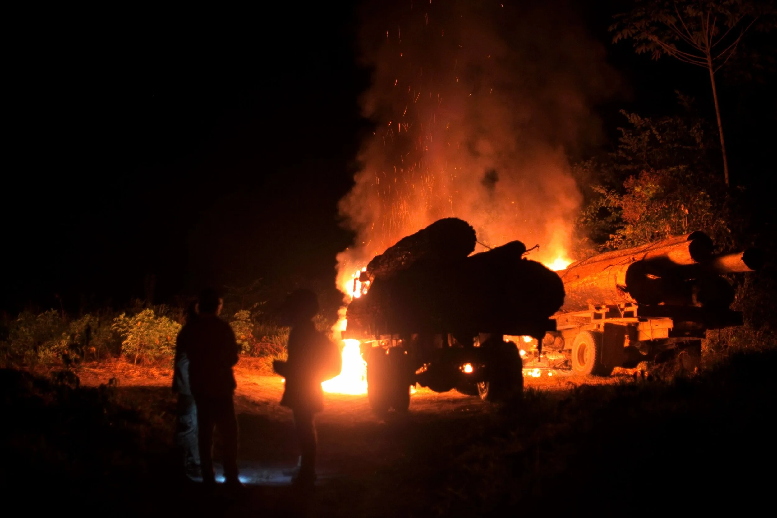 *Image of trees that had been illegally logged in indigenous territory being burned along with trucks to ensure the destruction of illegal logging equipment.