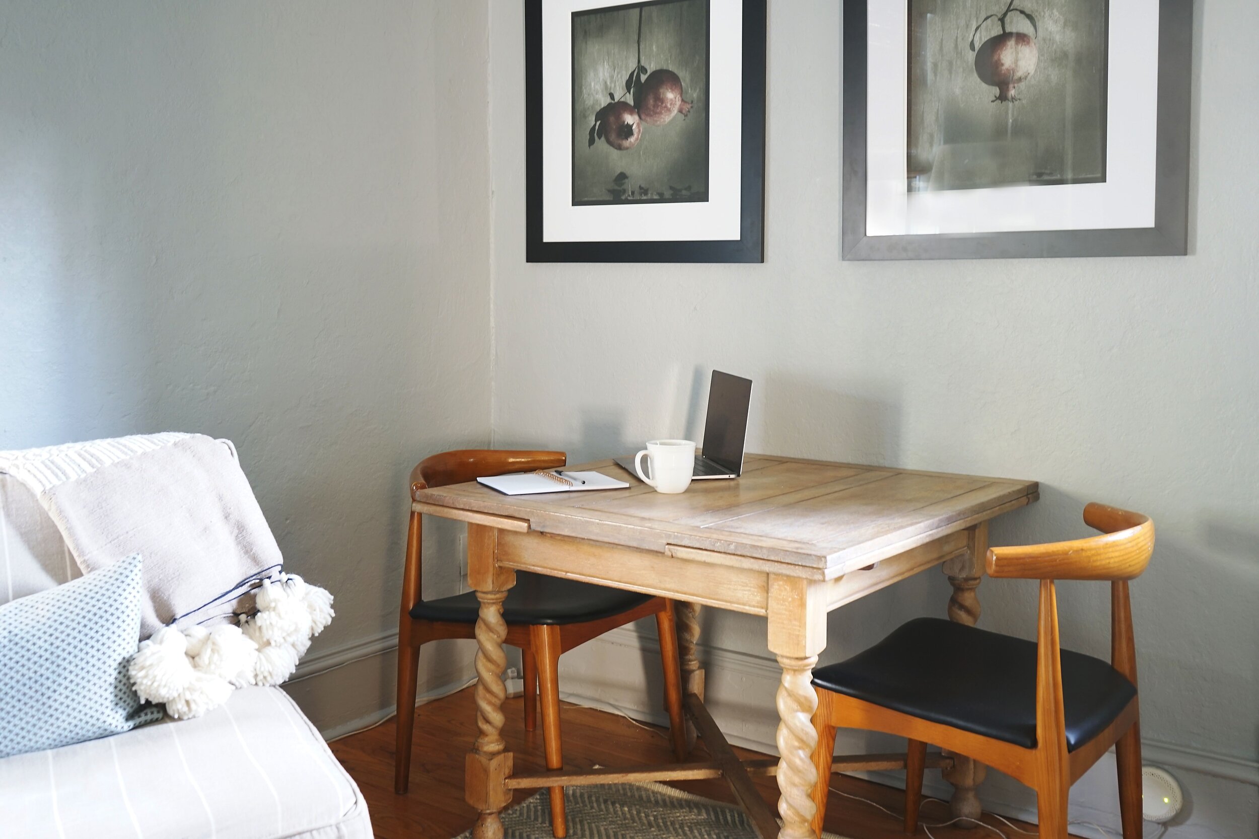 The nook with a table and chairs is filled with light from the front door and adjacent window, making it a lovely spot for reading and eating