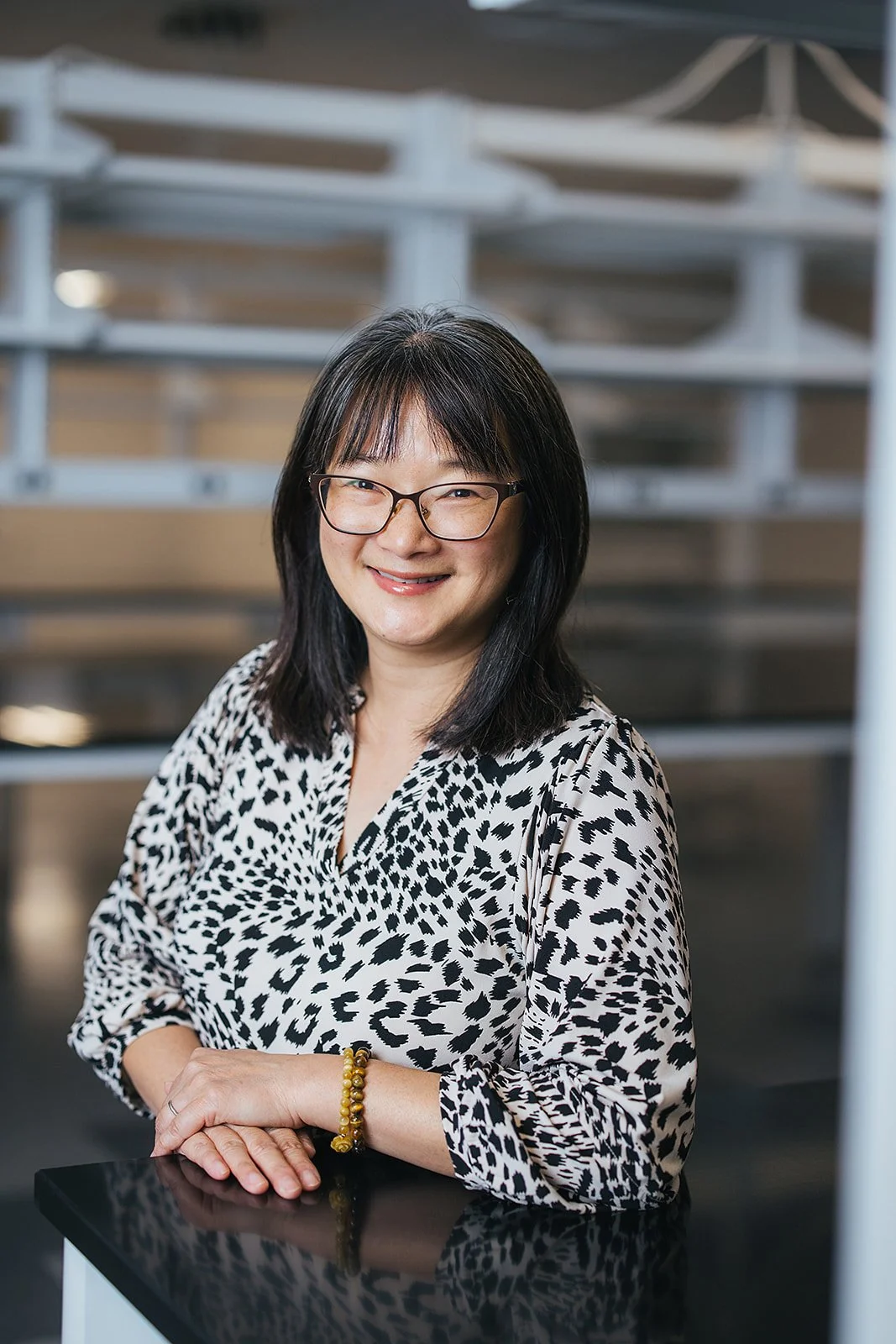 WomanSmilingHeadshotInWhiteAndBlackShirt