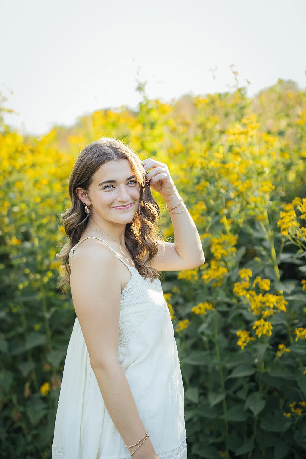 Senior Girl Portrait In Front Yellow Flowers