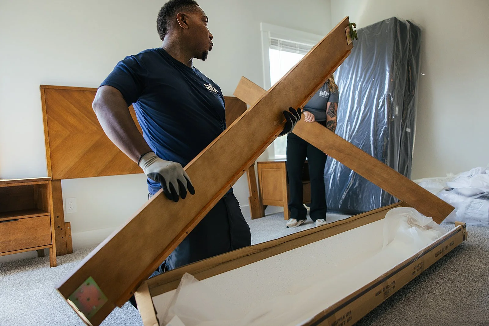 Behind-the-scenes photograph of AFR Furniture Rental arranging a living space in Durham, NC