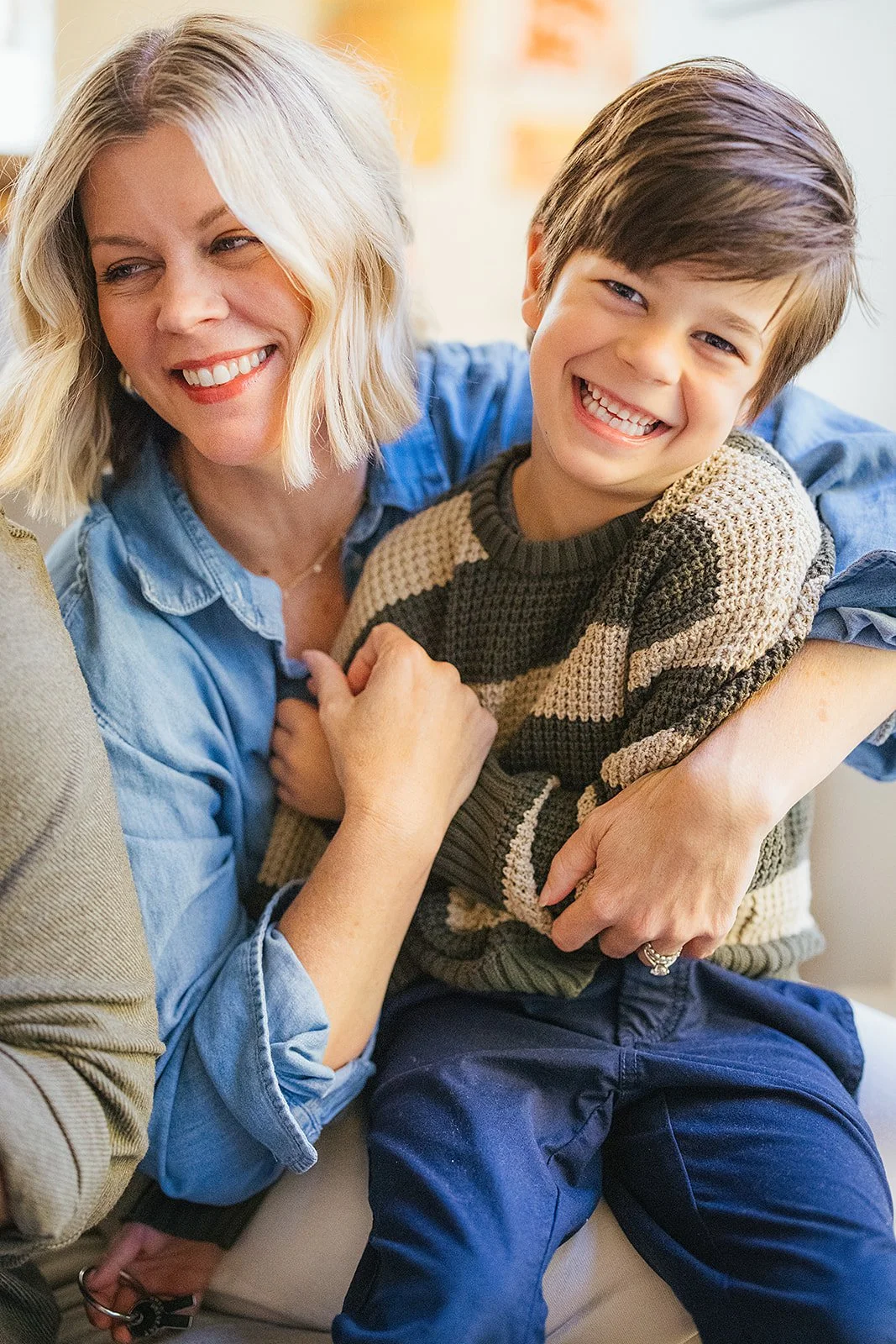 Mom Holding Smiling Son In Home Family Photo Session