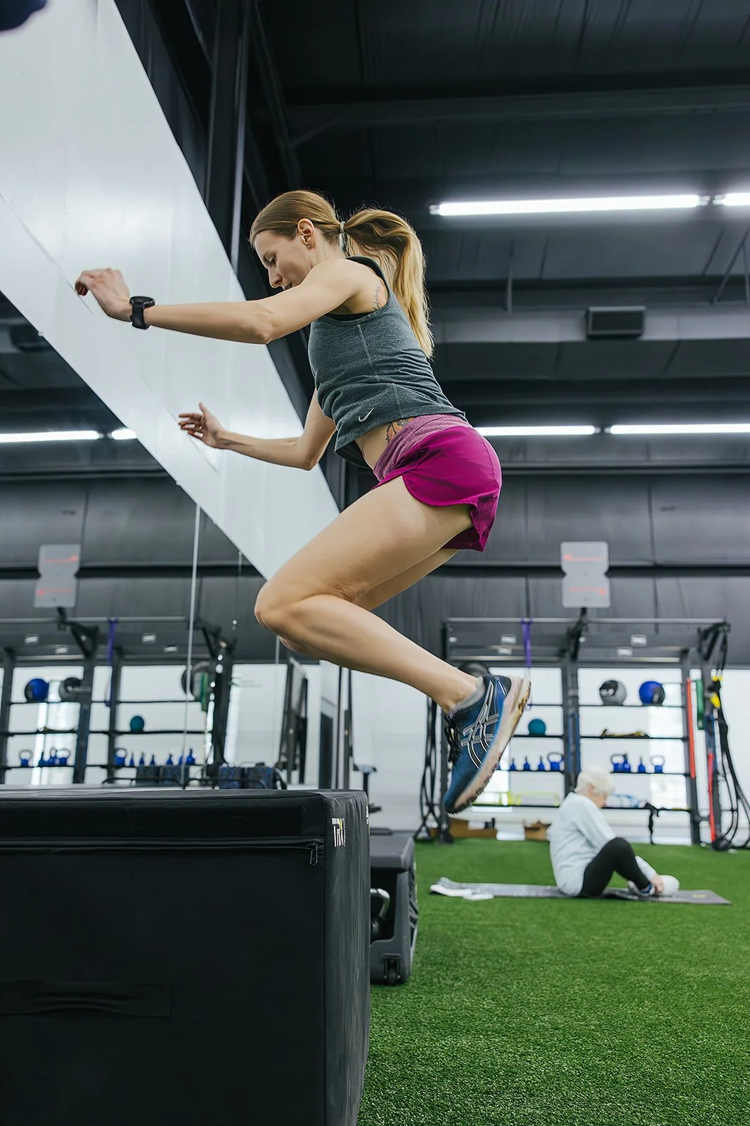 woman jumping demonstration at Durham, NC wellness center for local business photography