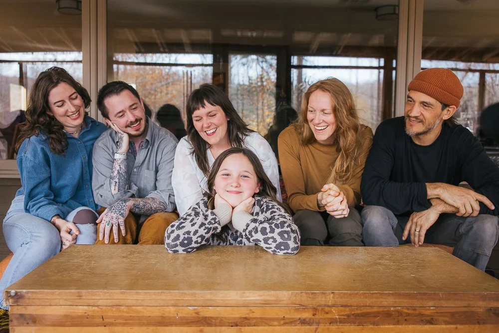 Family And Friends Smiling During In-Home Portrait Session