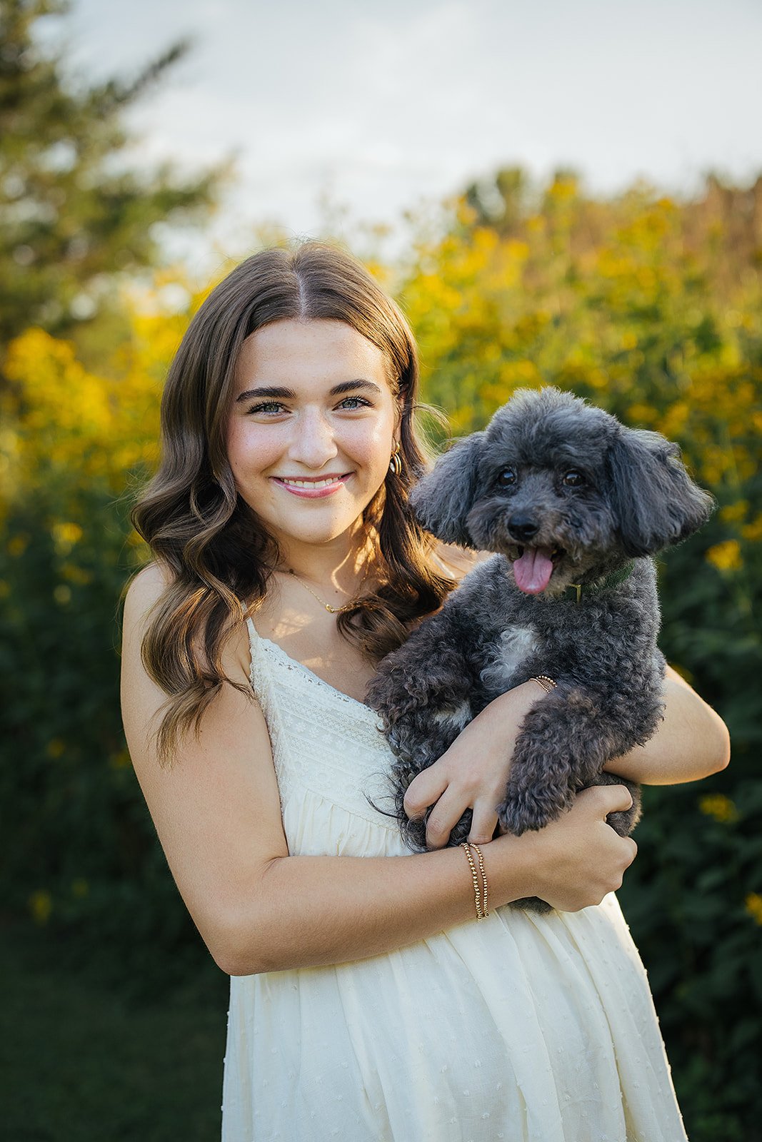 Senior Girl Smiling with Dog During Senior Photography Session