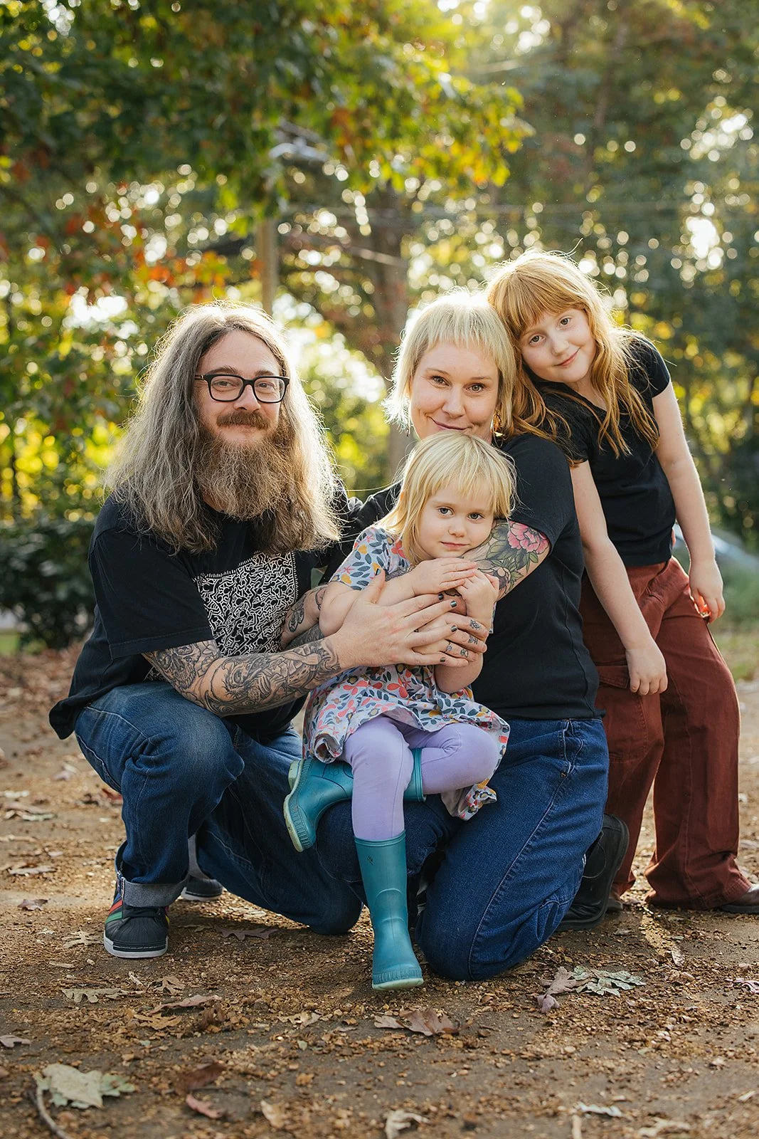 Family of Four Smiling Together Outside During Family Photo Session