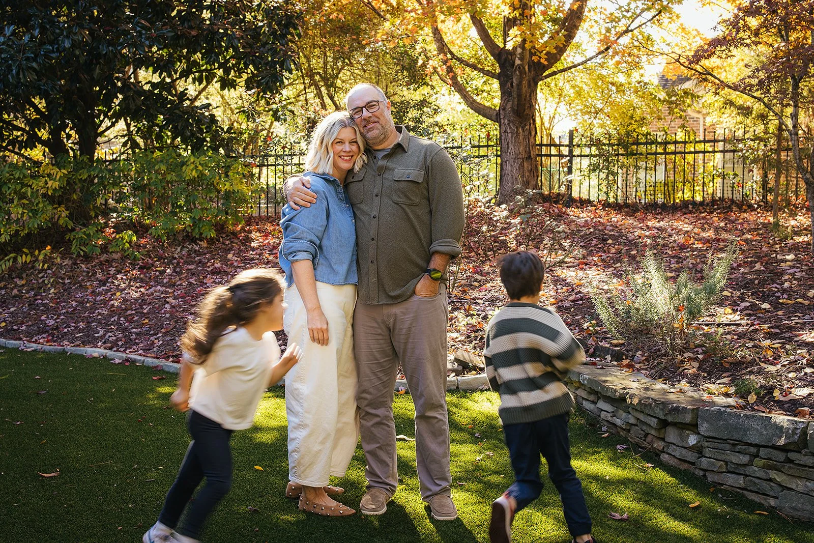 Kids Running Around Smiling Parents in Backyard