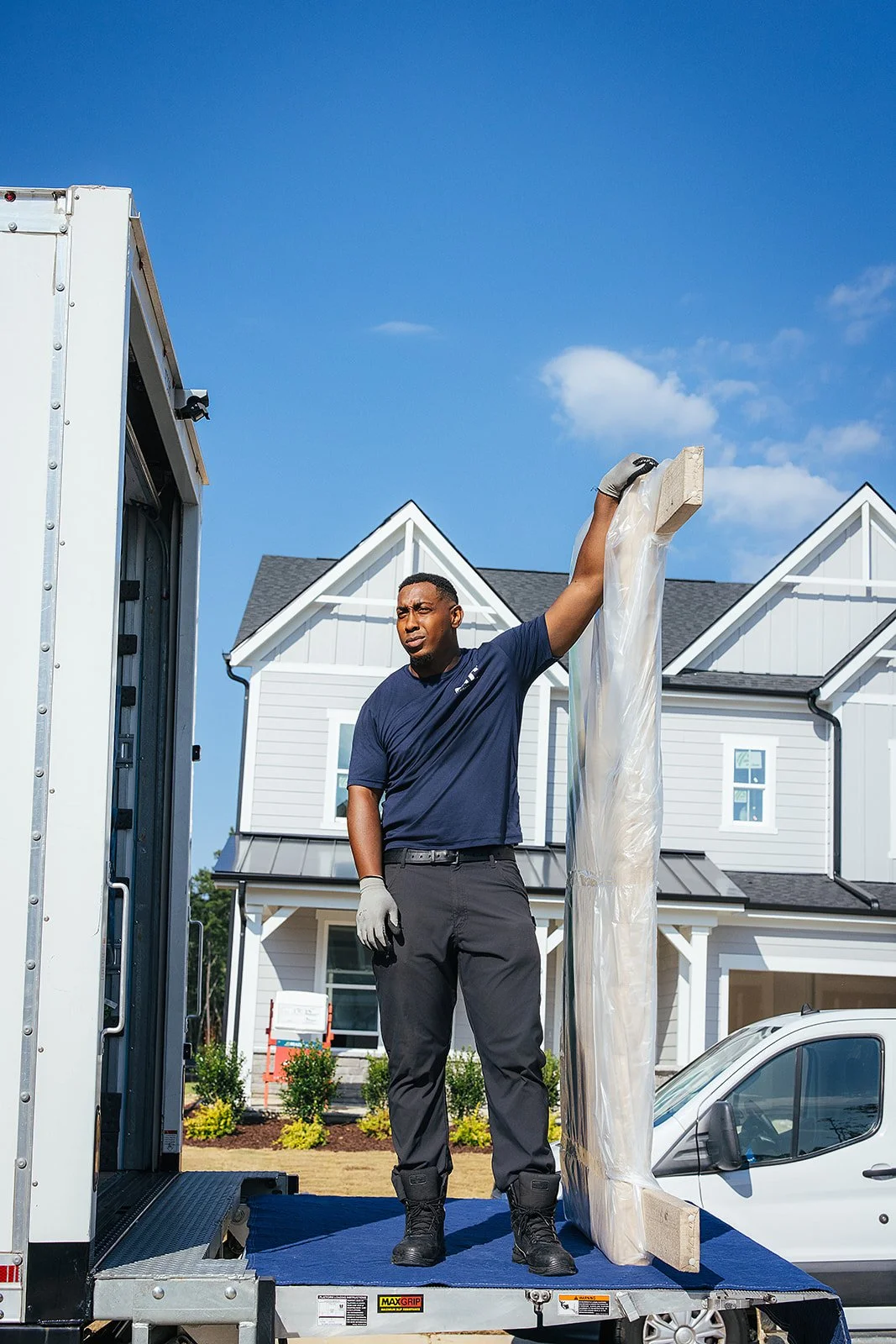 AFR Furniture Rental team moving furniture into a Durham home during a commercial photography session