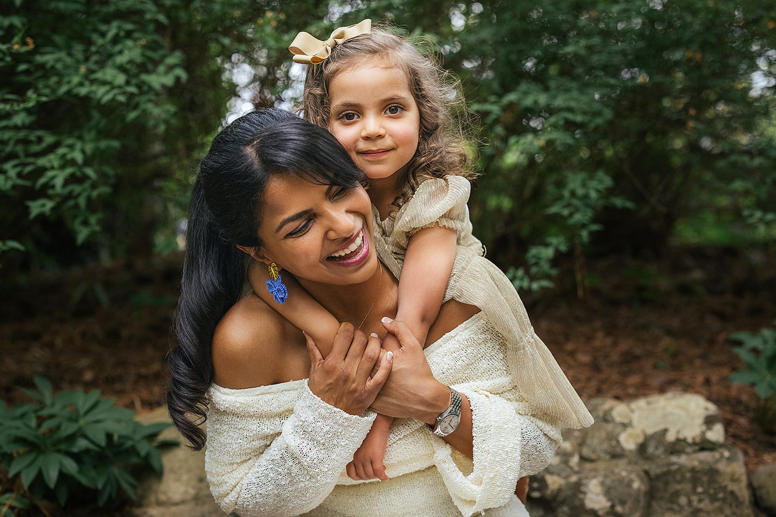 Young Girl Handing on Mom's Shoulders