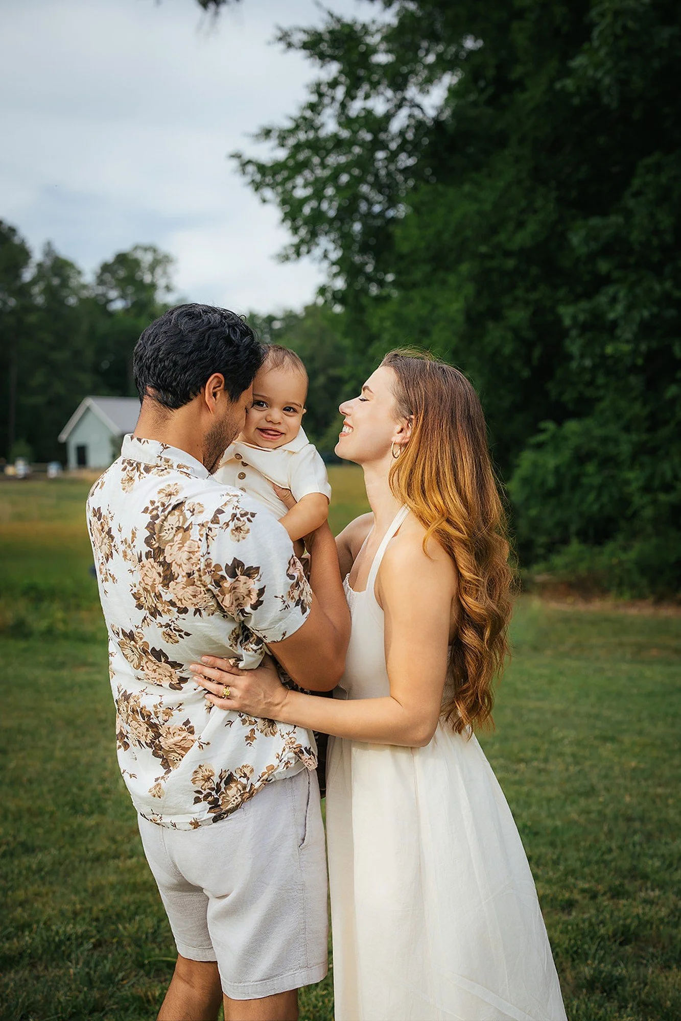 Parents Kissing Baby And Smiling