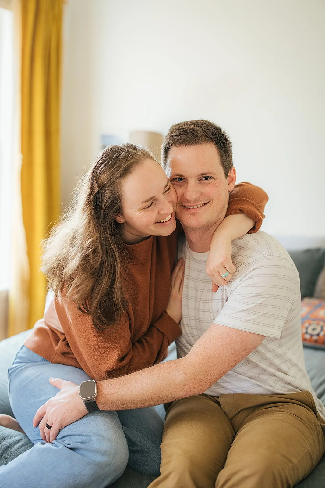 Parents share a warm smiling moment together during Durham in-home lifestyle family photography session