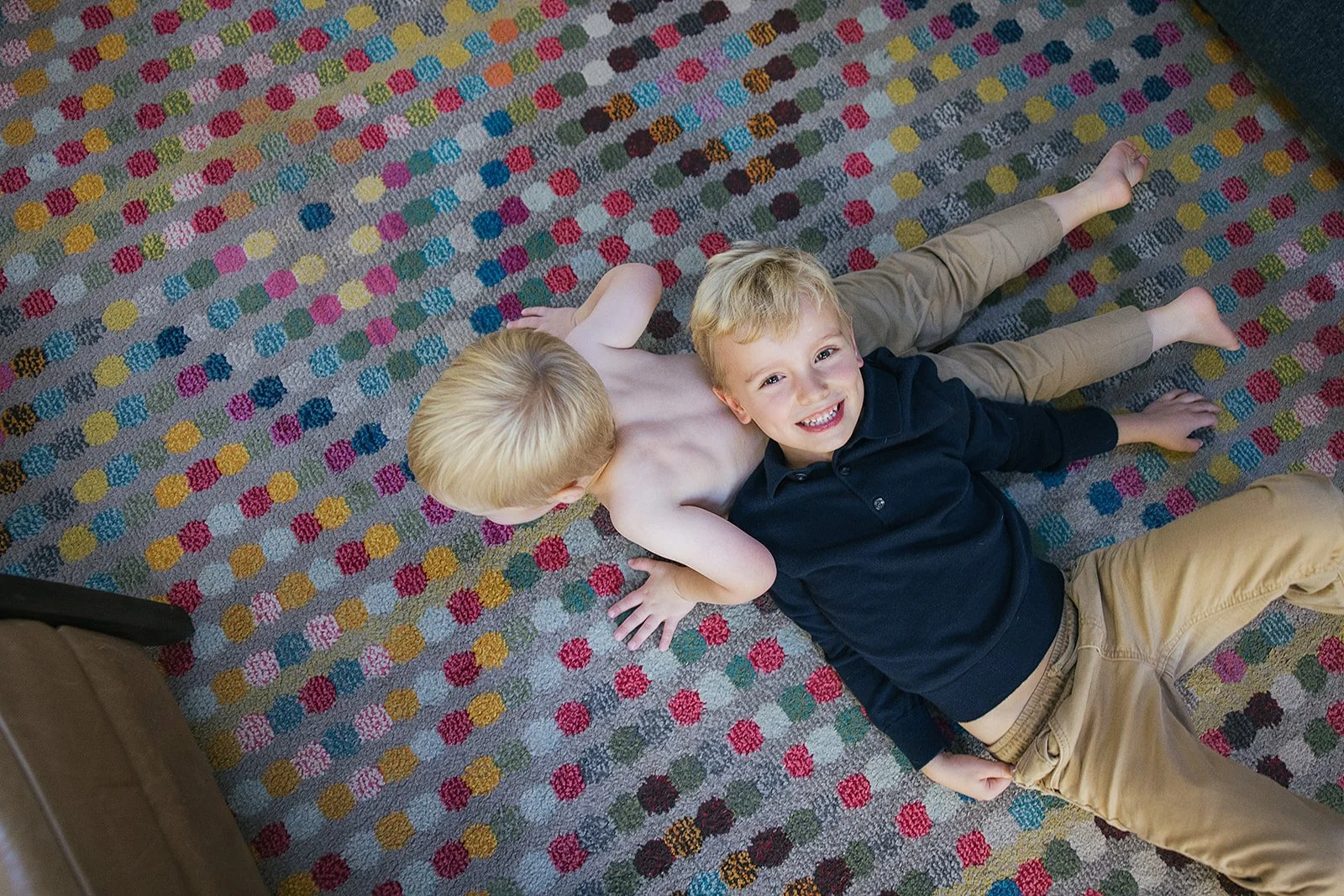 BrothersWrestlingOnCarpetFamilyPhotoSession