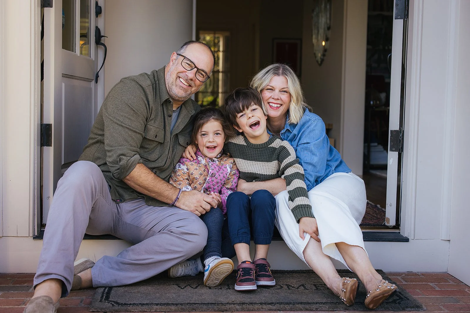 Family of Four Sitting at Front Door During Family Photo Session