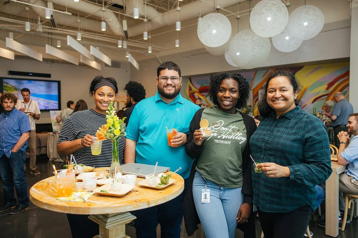 Team members laughing together at a Triangle corporate event