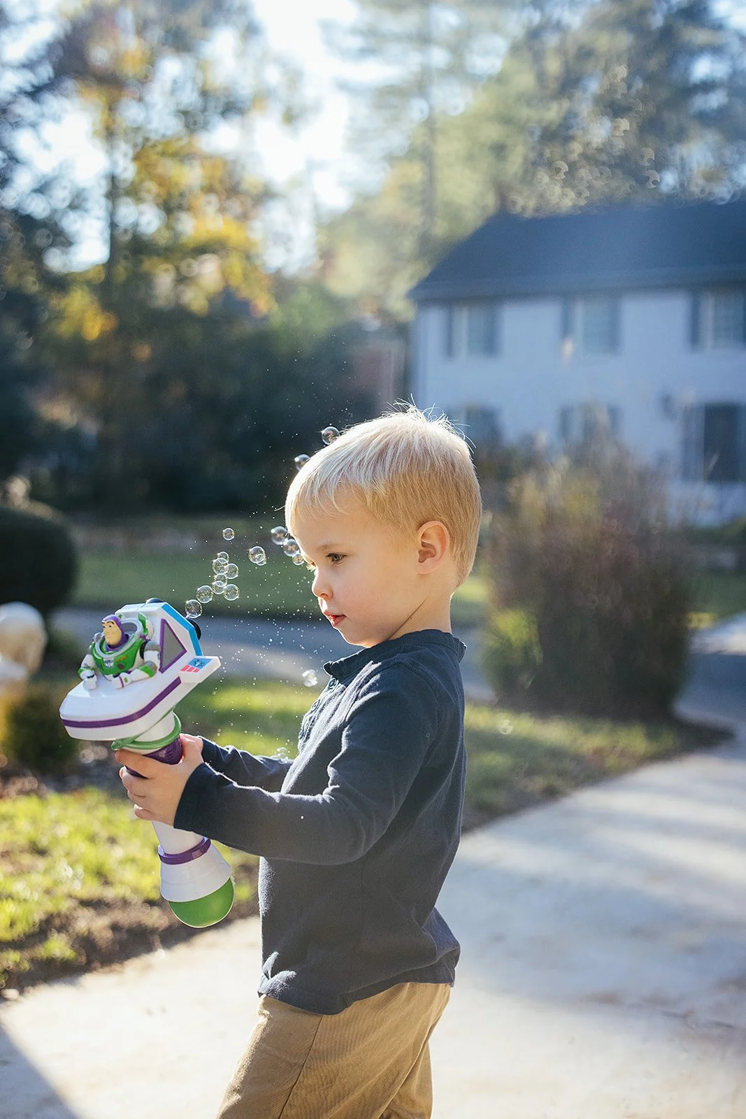 YoungBoyPlayingWithBubblesFamilyPhotoSession