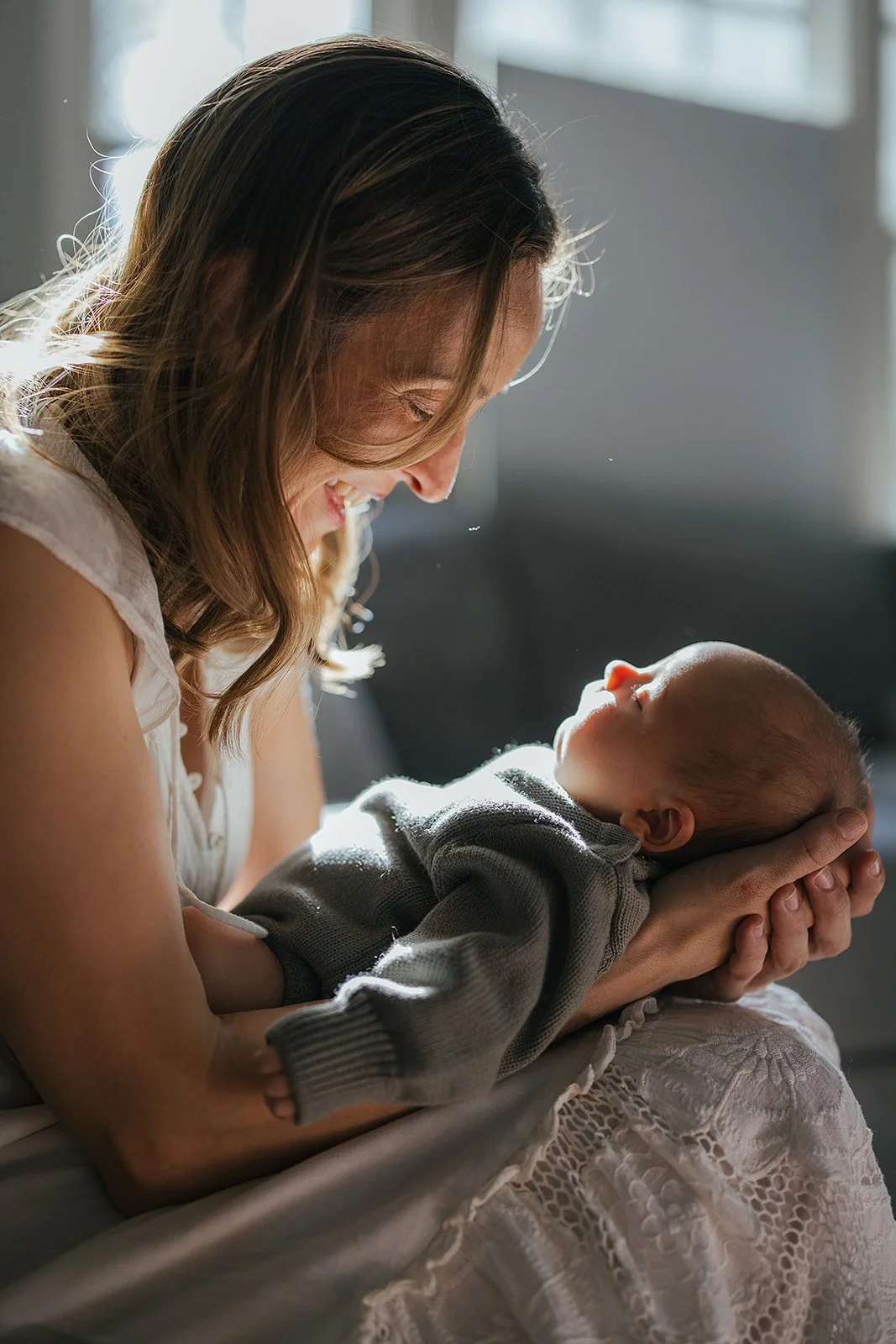 Mother holds newborn in a Durham NC photoshoot