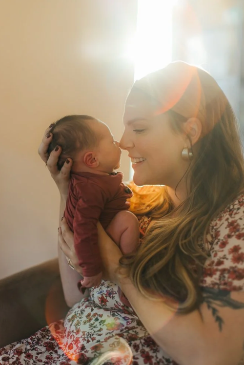 Mom kissing newborn baby nose