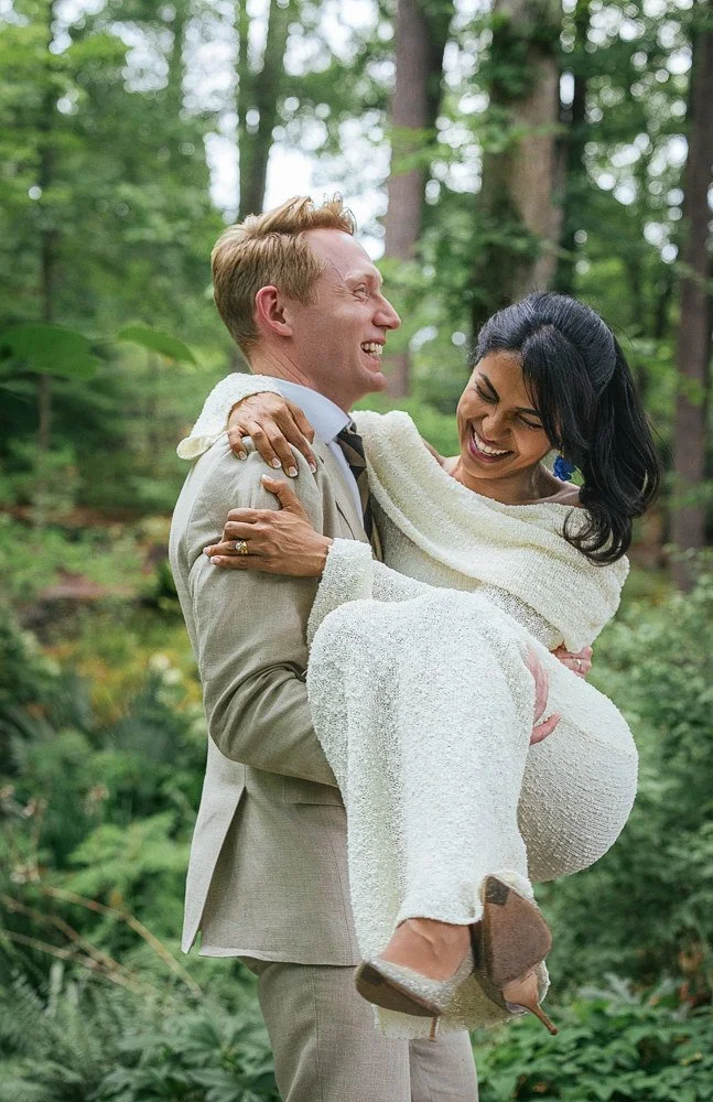 husband and wife smile after vow renewal ceremony at duke gardens in Durham NC