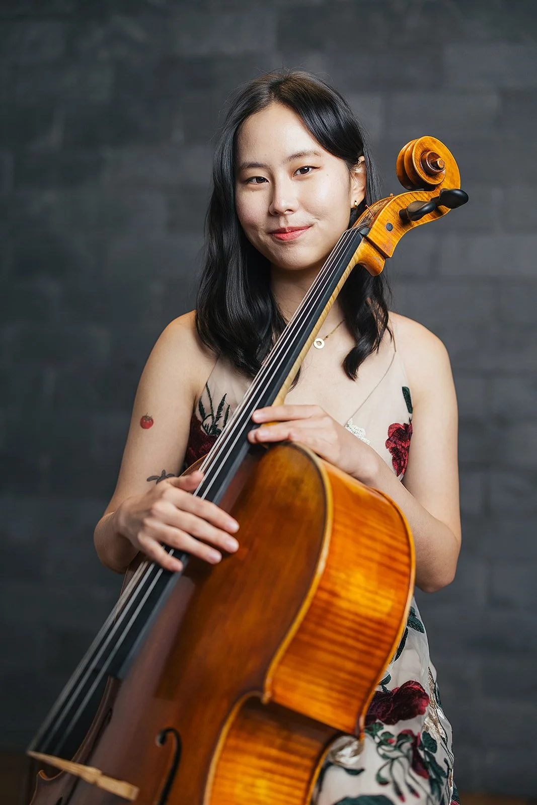 Woman Smiling and Holding Cello
