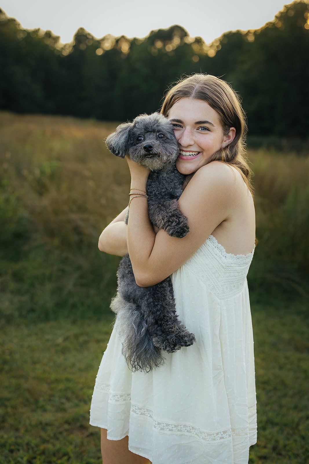 Senior Posing with Dog During Photo Session