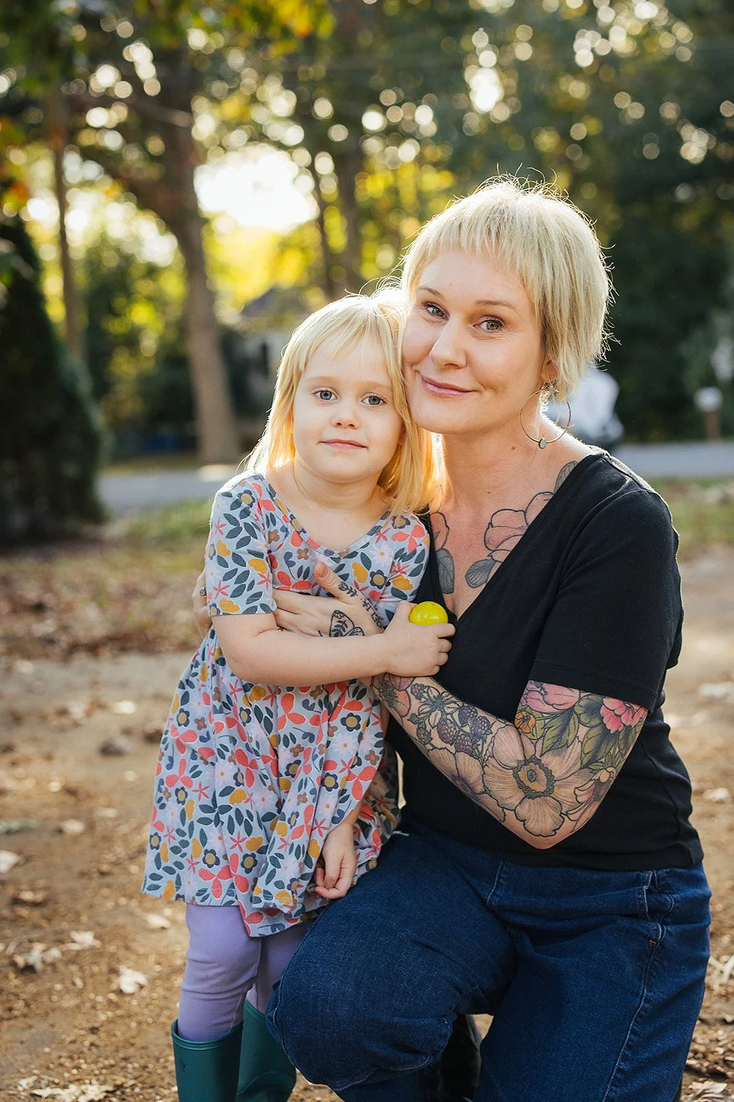 Mom and Daughter Smiling Together Outside During Family Photo Session
