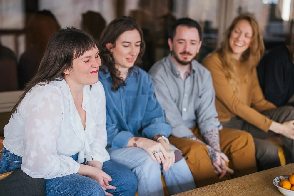 Friends Sitting On Couch Outside In-Home Family Photography Session