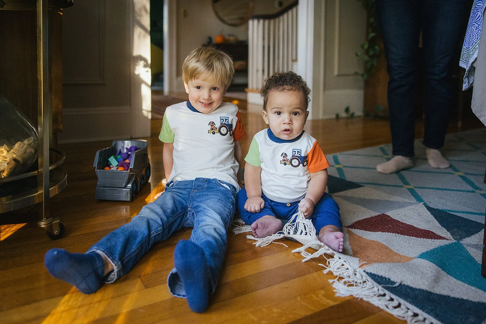 Two Young Sons On Living Room Floor During Family Photo Session