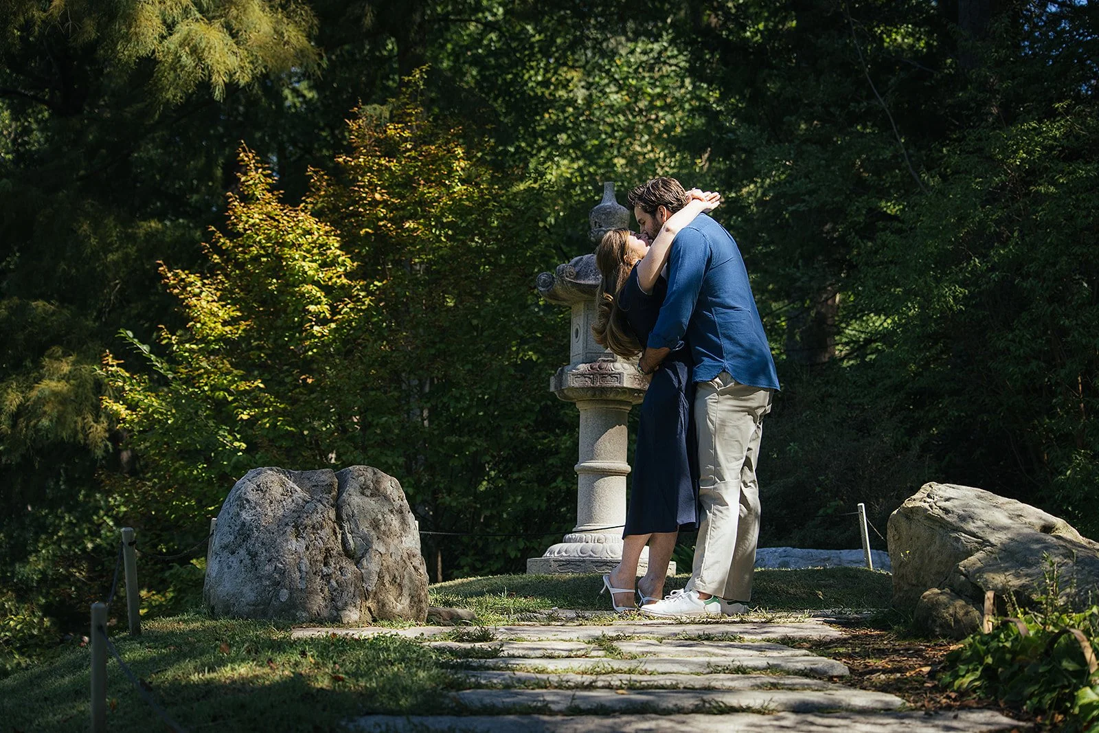 Couple kissing after getting engaged at Sarah P Duke Gardens in Durham NC