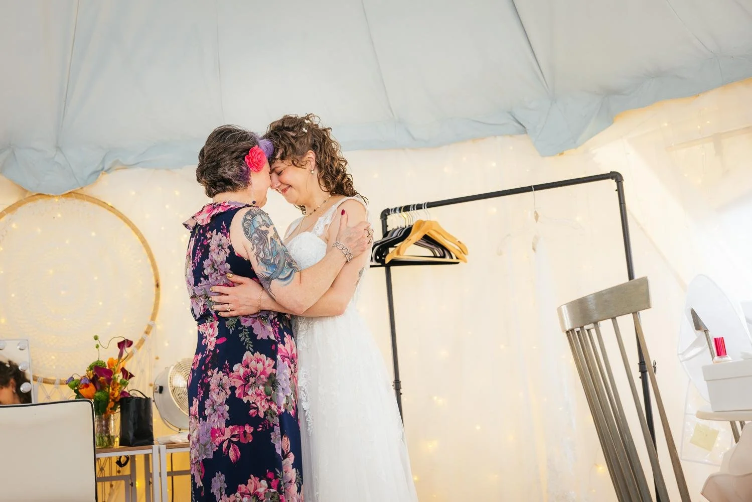Bride and her mother sharing an emotional forehead-to-forehead moment inside the white bridal tent while getting ready at Honeysuckle Tea House Chapel Hill NC wedding