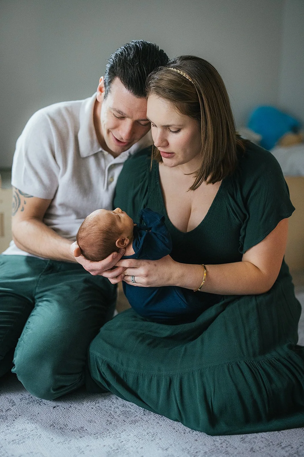 Parents hold their newborn baby for photography at home in Durham, NC