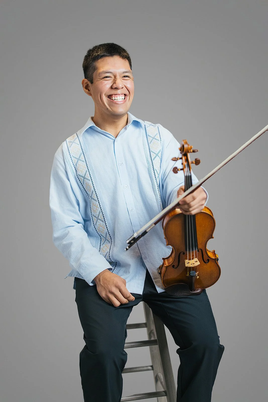 Man Smiling Holding VIolin