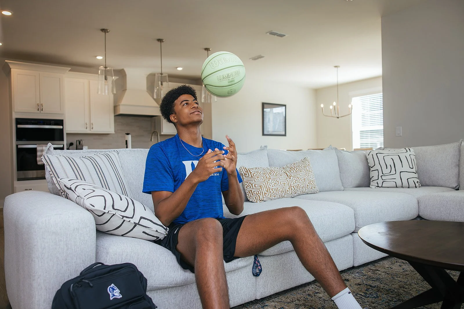 Duke basketball player in home done by AFR Furniture Rental in a Durham home