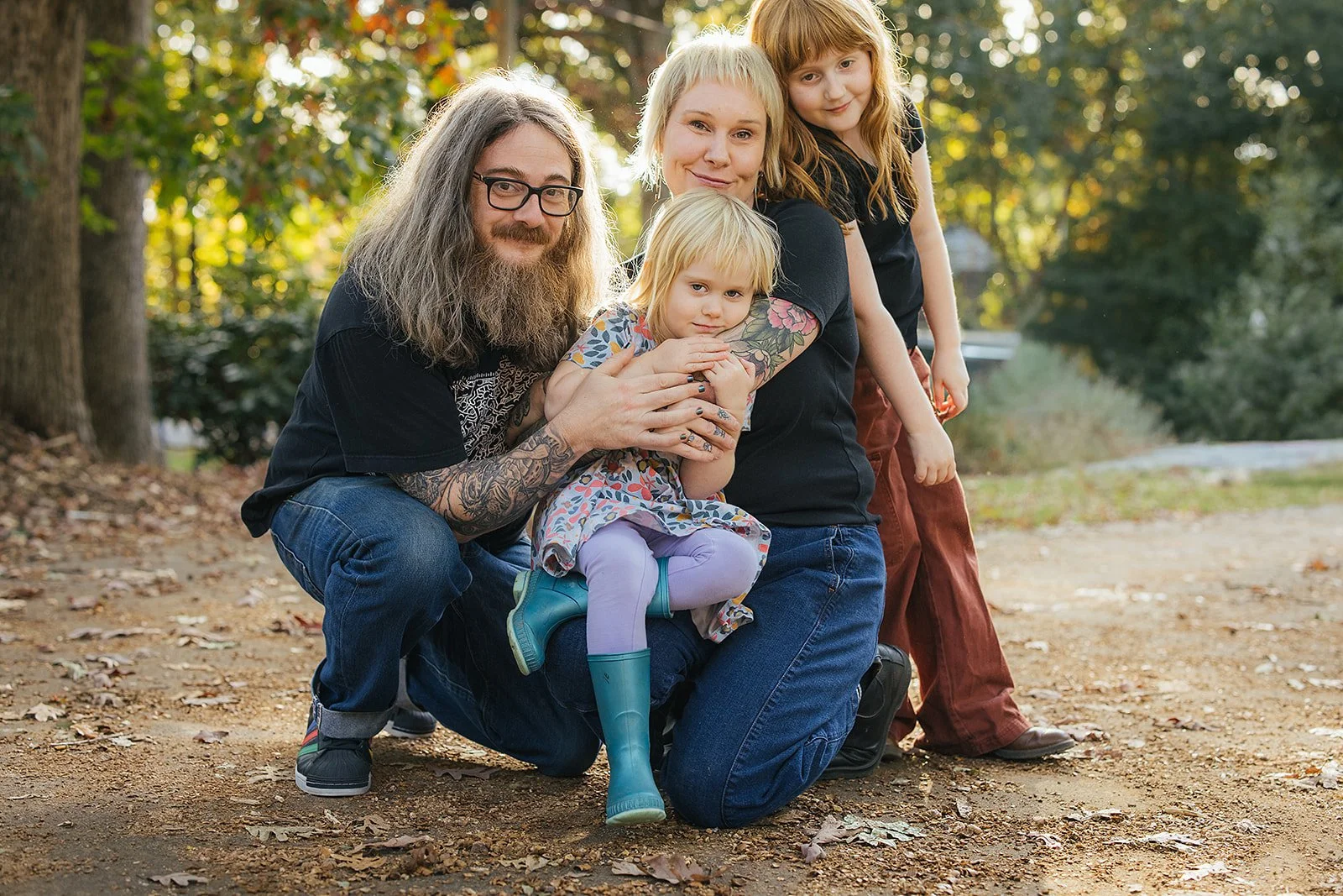 Family of Four Smiling Together Outside During Family Photo Session