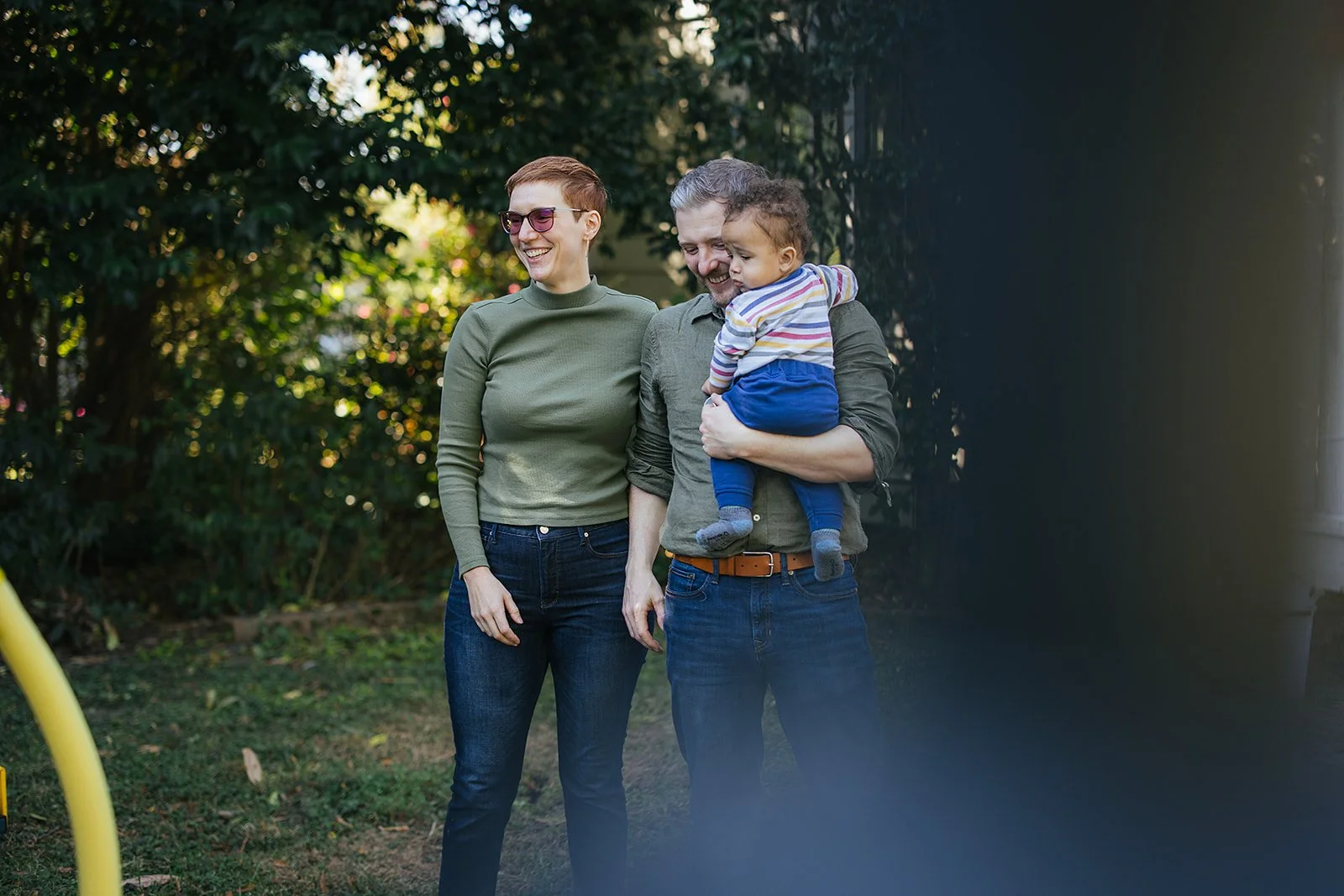 Parents Holding Baby in Backyard