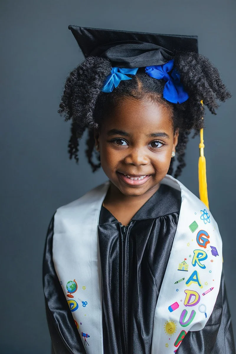Young Girl Smiling in Graduation Cap and Gown