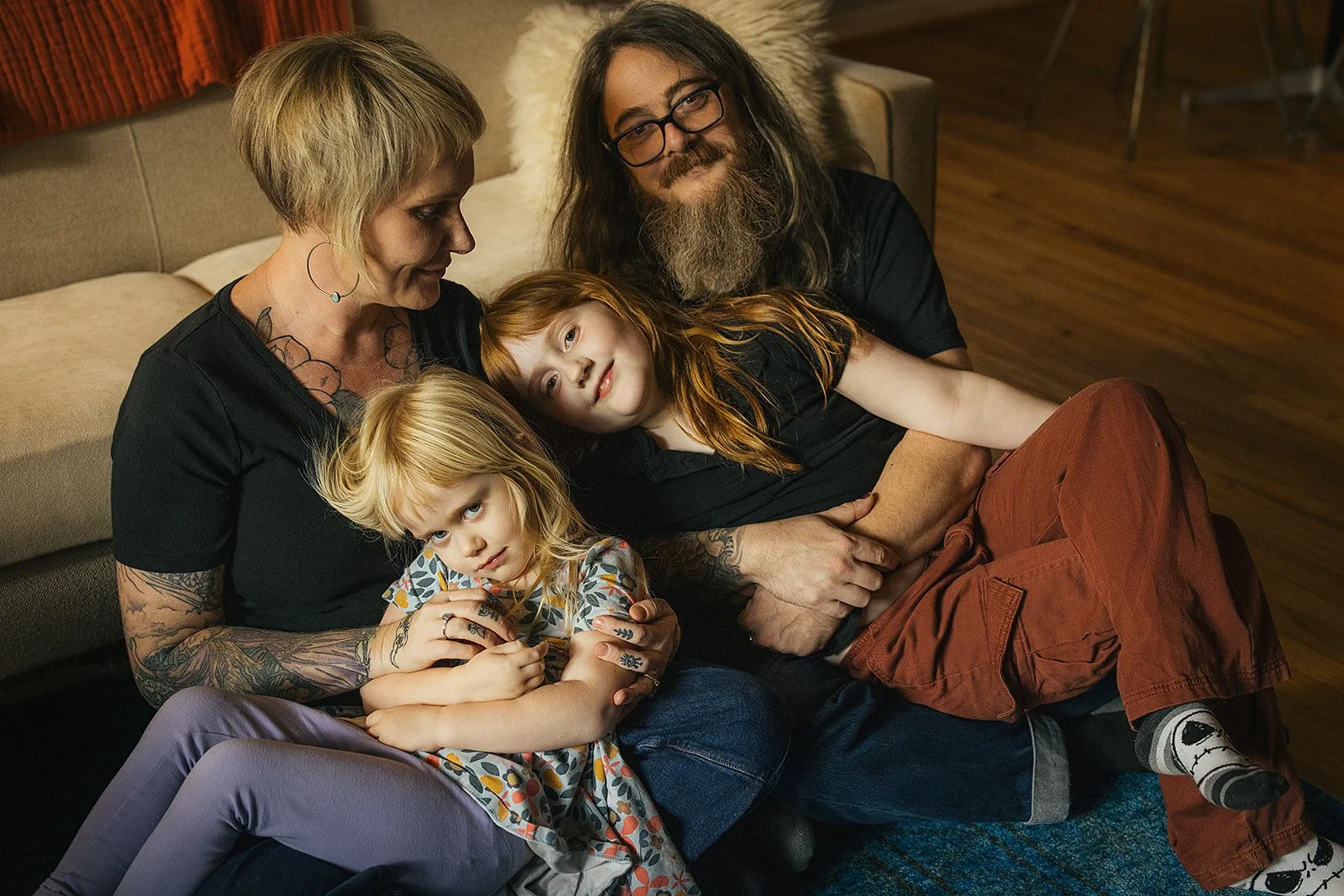 Family of Four Sitting Together in Living Room During Family Photo Session