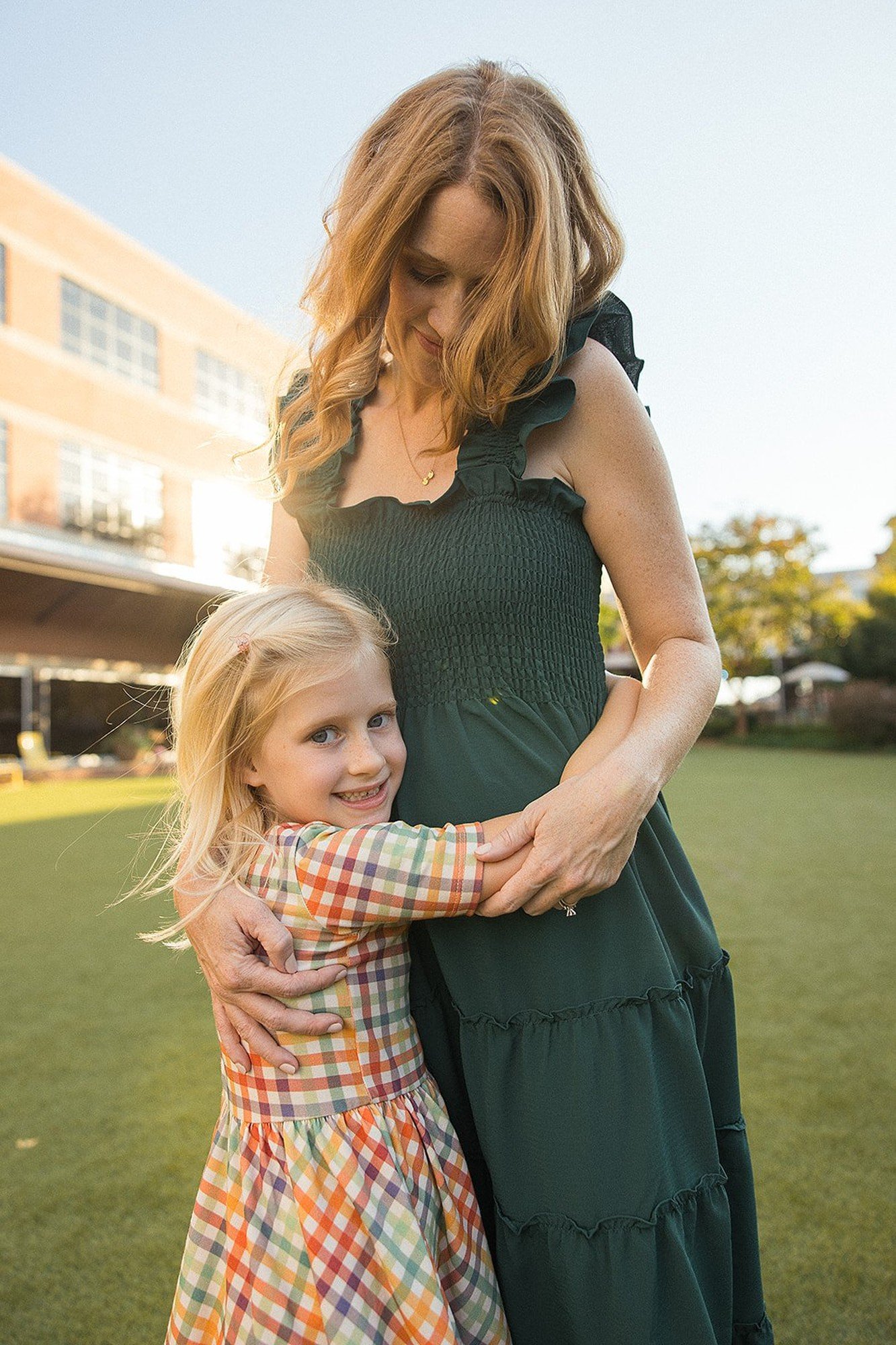 Mother holds her daughter in coordinating sundresses during a family photoshoot in Durham NC