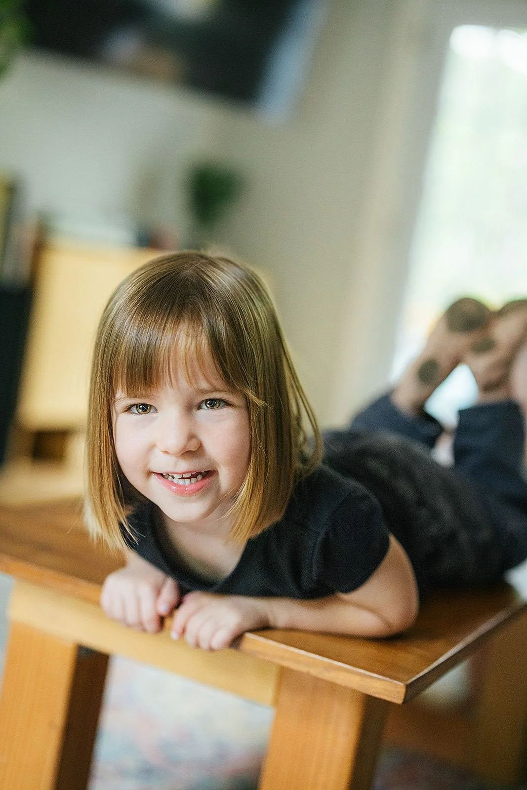 Young Girl Smiling During At-Home Family Photography Session