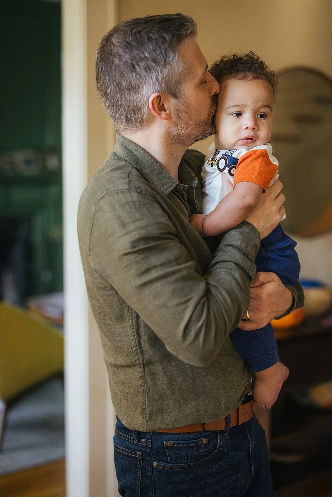 Dad Snuggling Young Baby During Family Photo Session