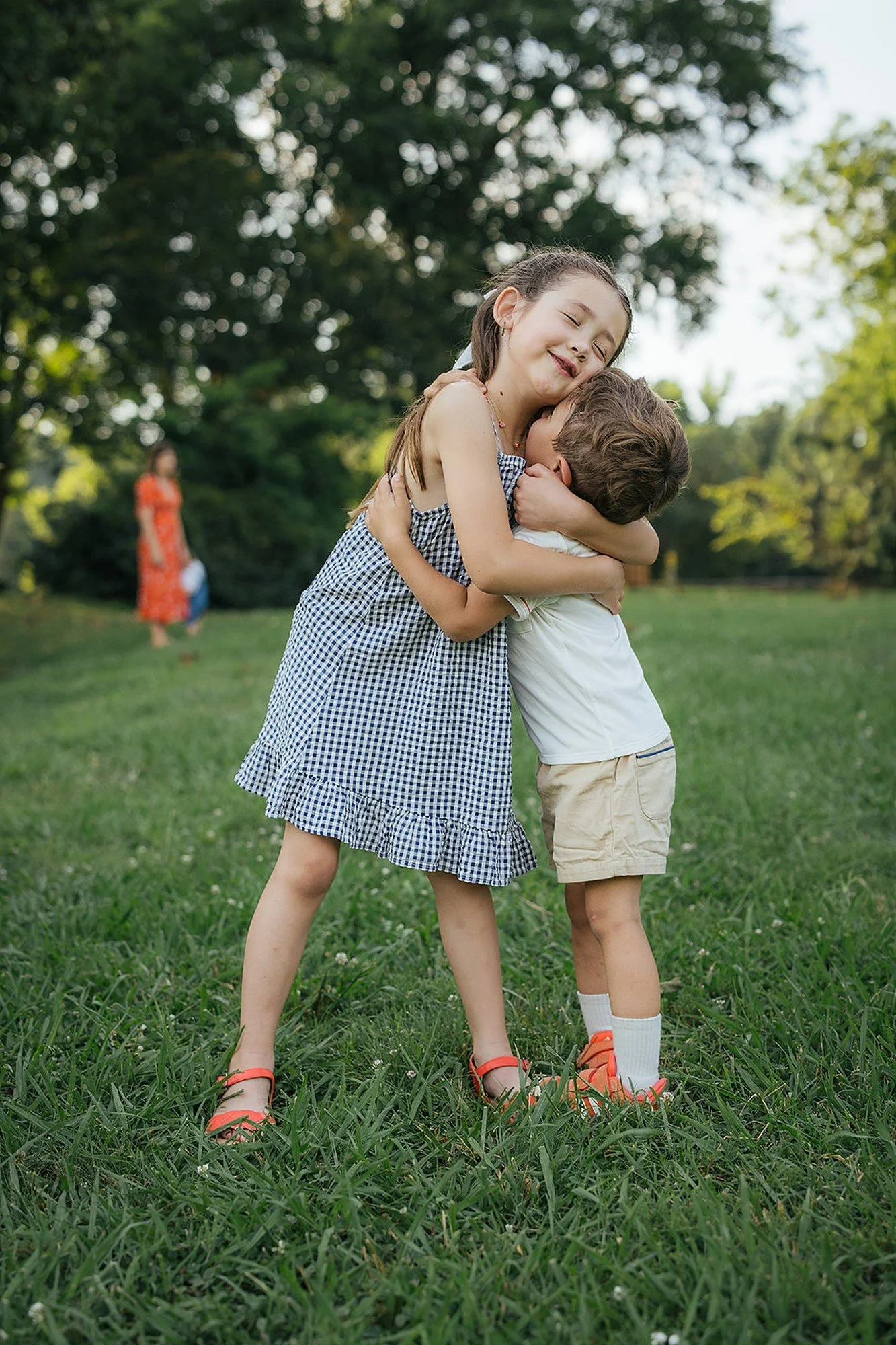 Two kids hug each other during a summer family photoshoot in Durham NC