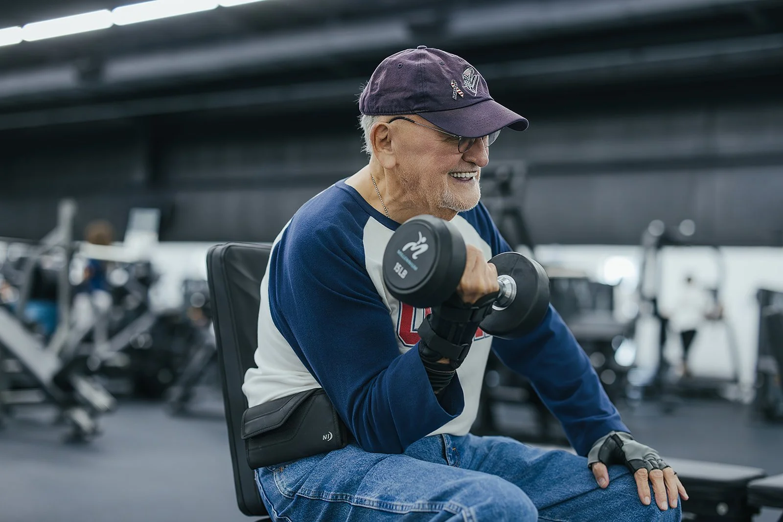 older man lifting weights poses for local wellness business photography in Durham, NC