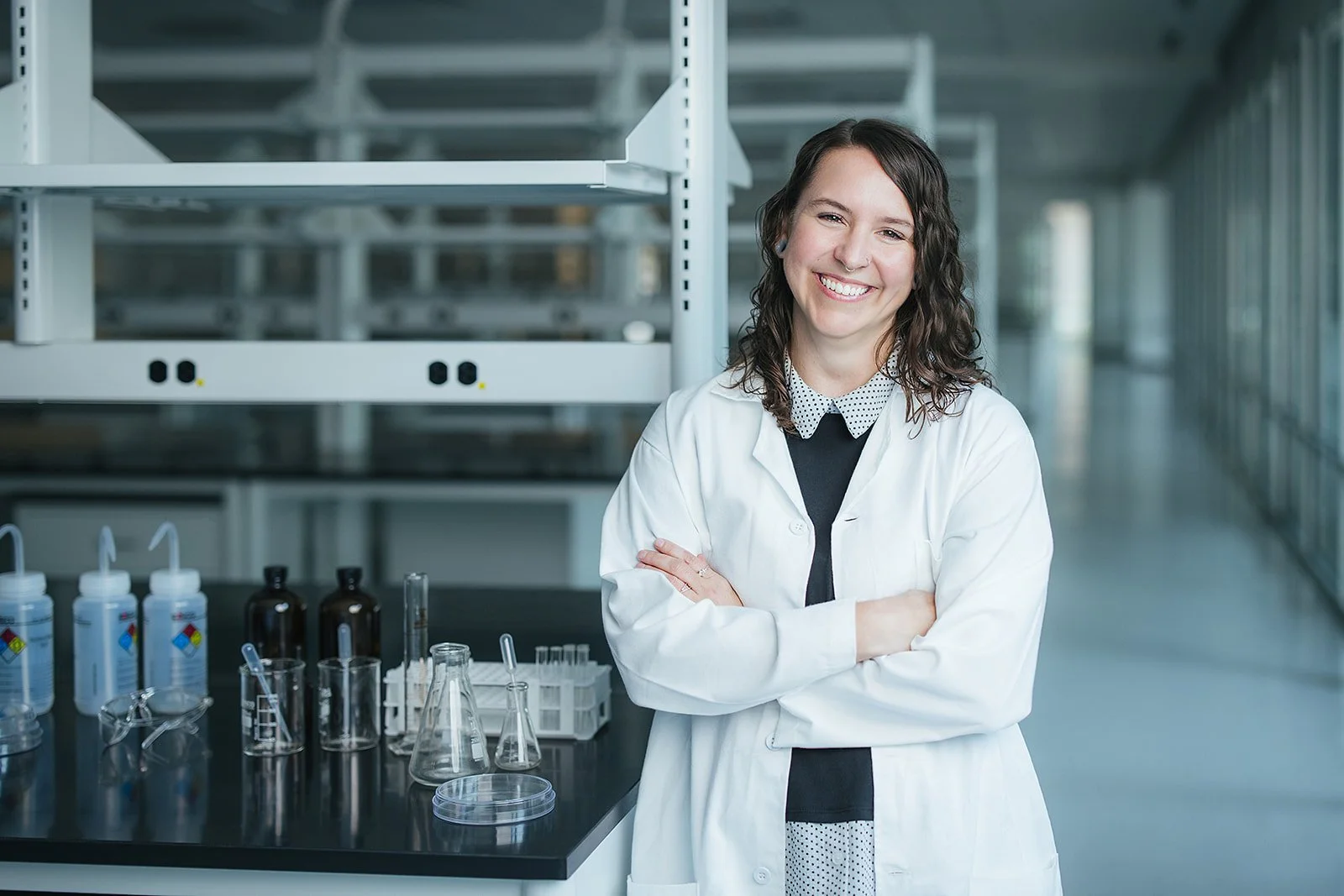 WomanArmsCrossedInWhiteLabCoat