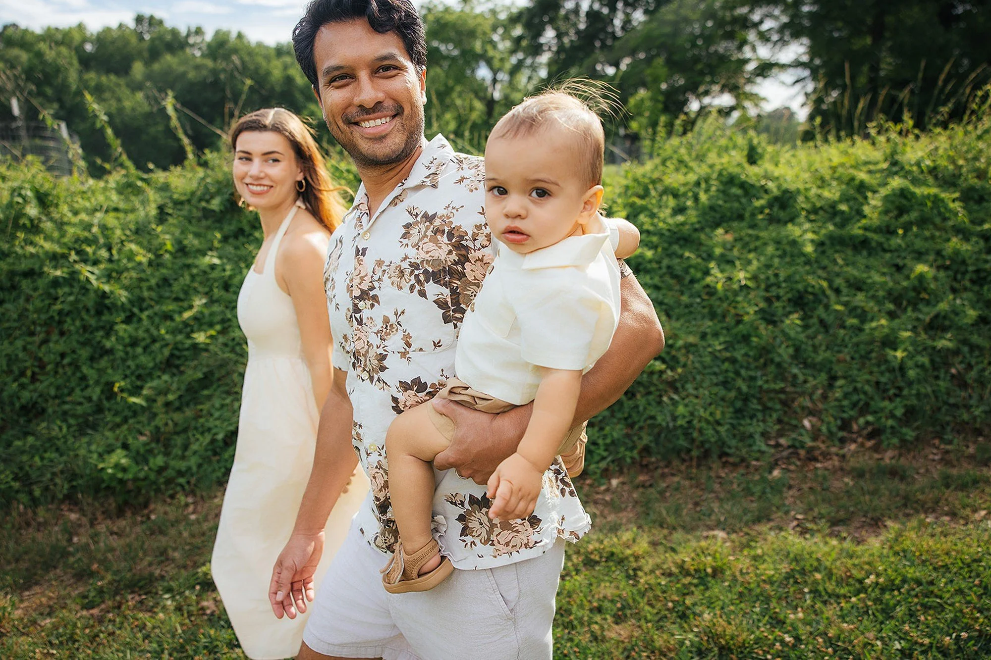 Parents Smiling Holding Baby in Durham NC Park