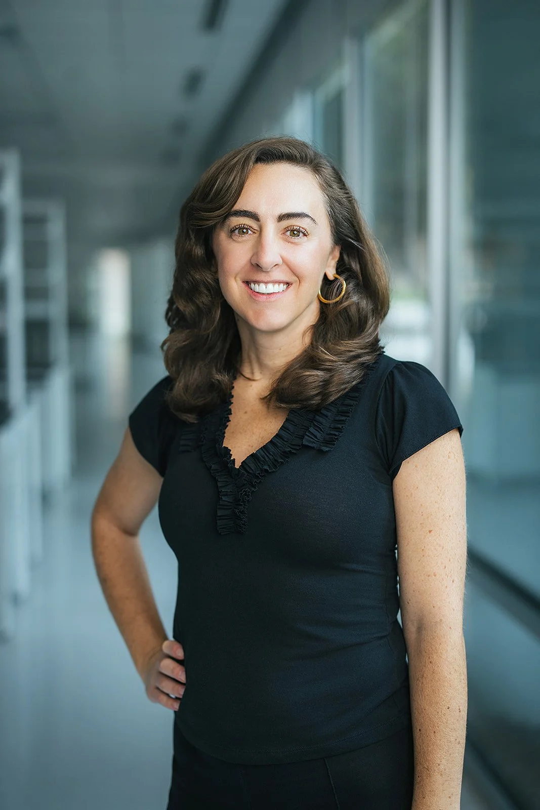 WomanHeadshotBlackDressHandOnHip