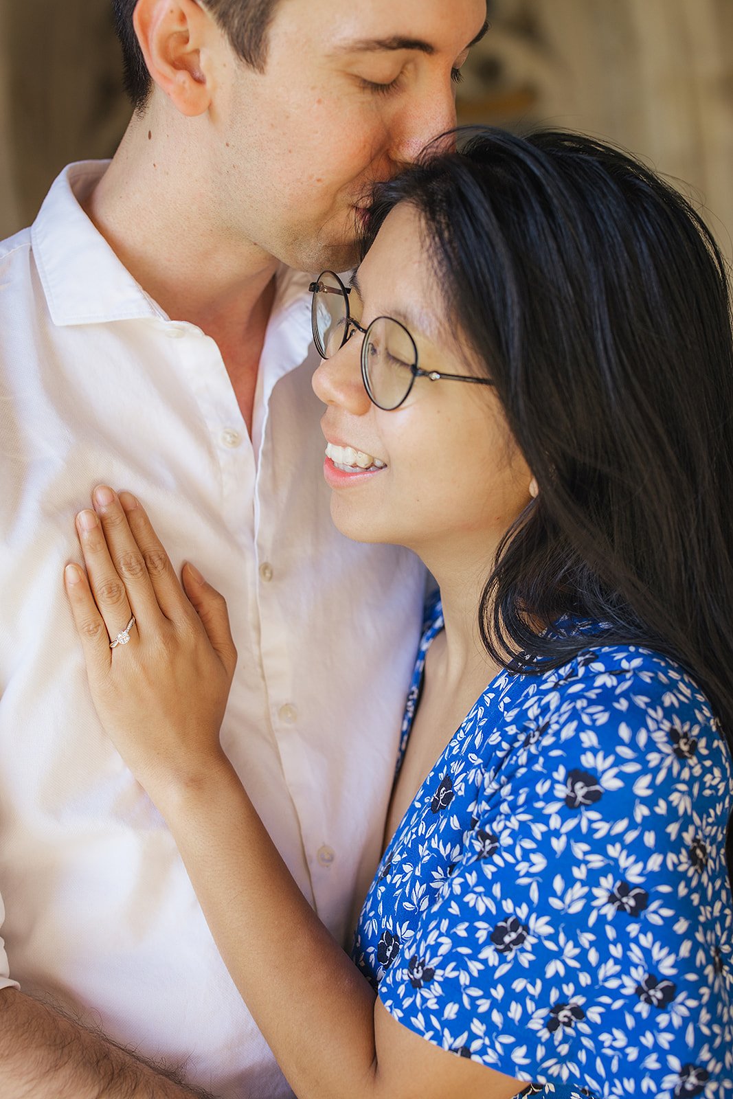 A couple shares a sweet moment after their surprise engagement during a photoshoot at Duke Gardens in Durham, NC