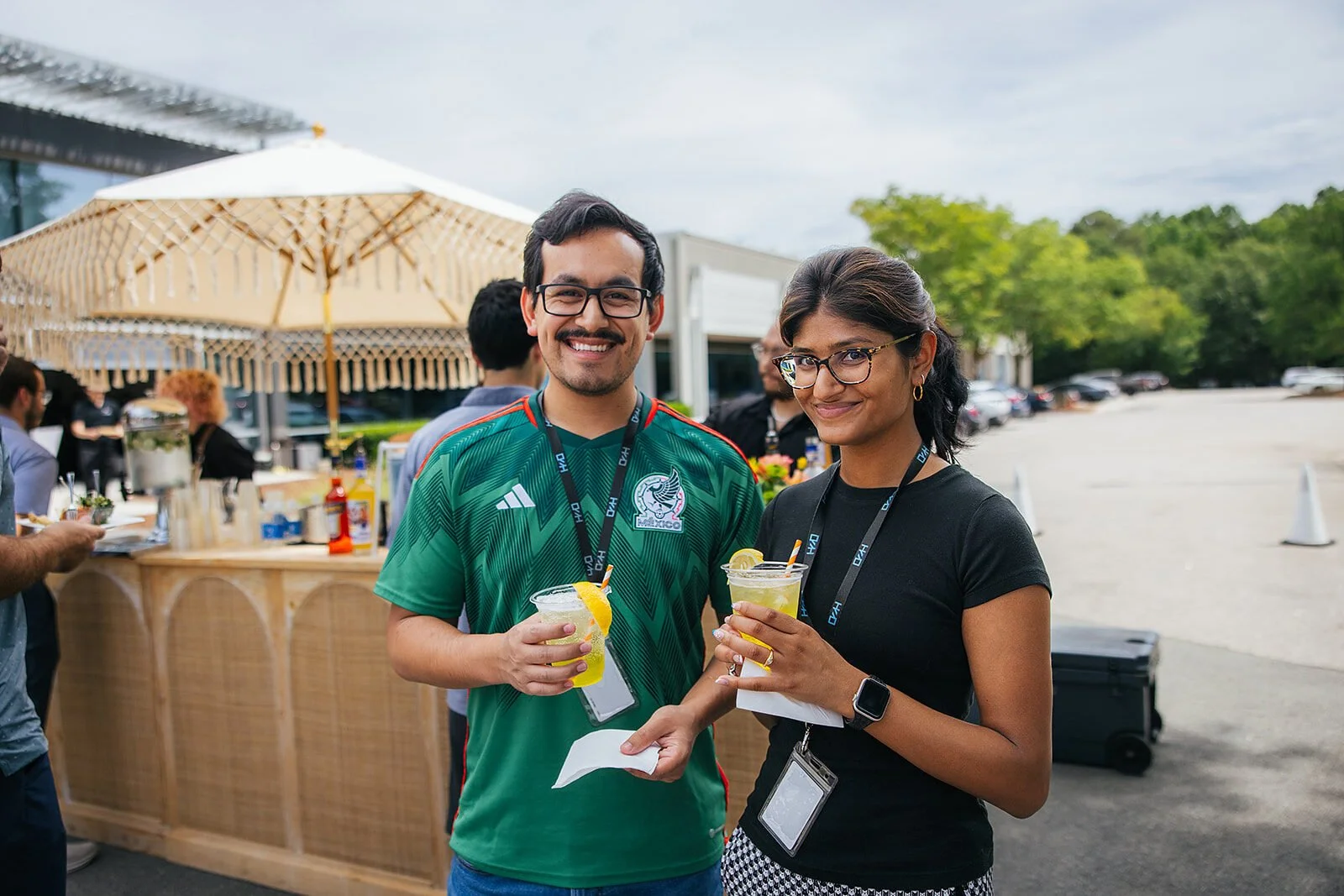 Two Raleigh Event Attendees Holding Drinks