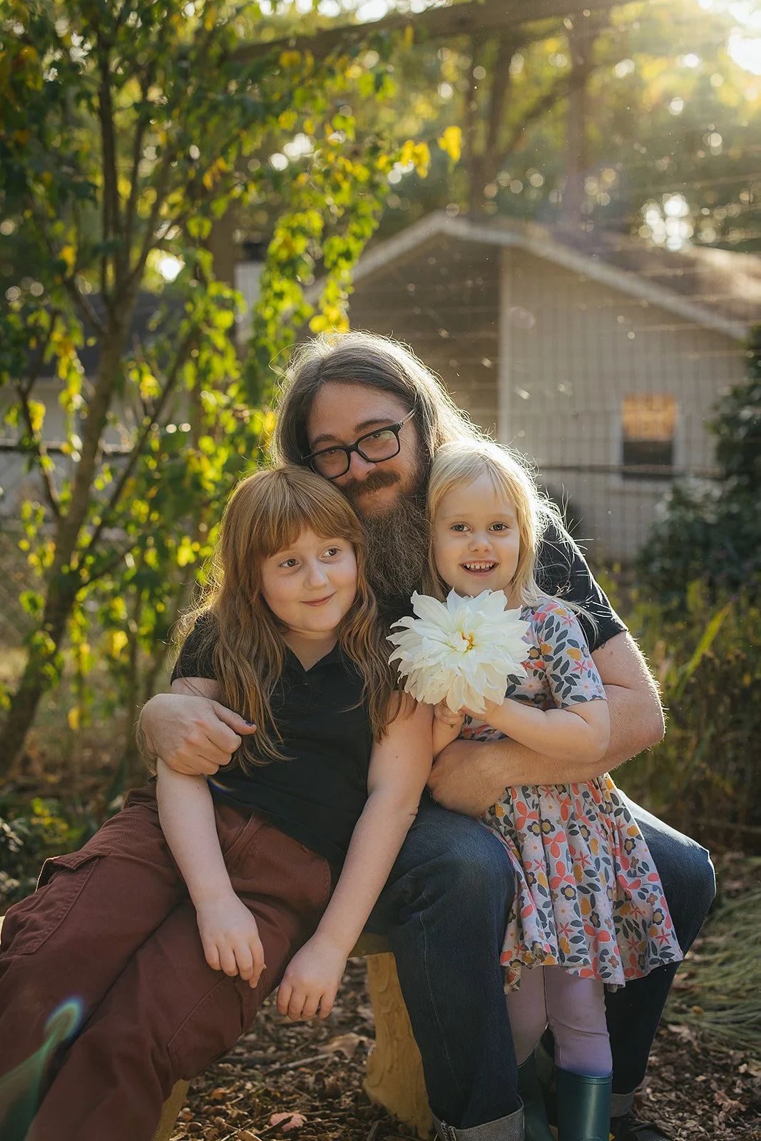 Daughter Holding Flower with Sister and Dad Family Photography