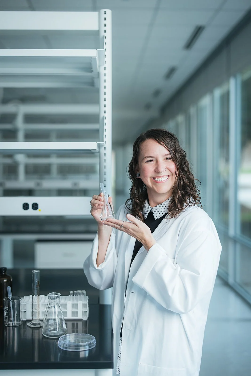 WomanSmilingHoldingGlassBeaker