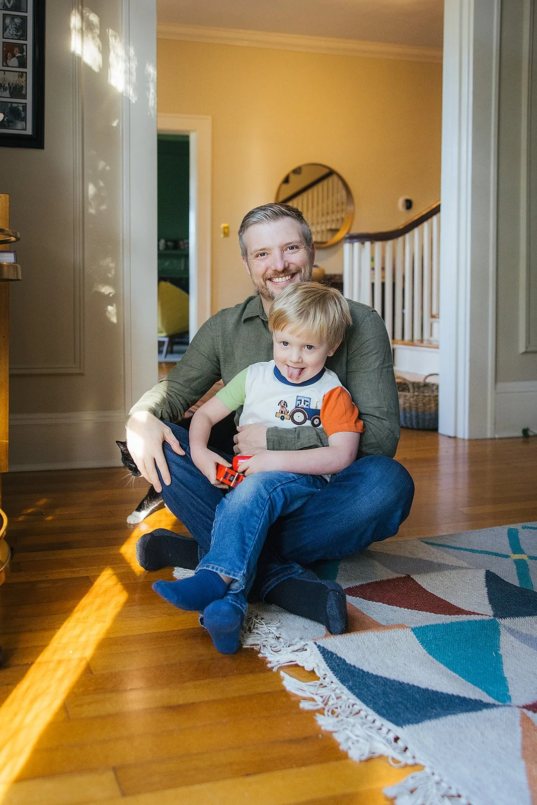 Dad and Son Sitting Together on Living Room Floor